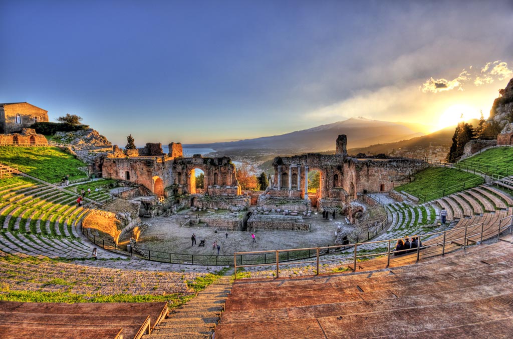 The Greek Theatre of Taormina with the Etna volcano in the background